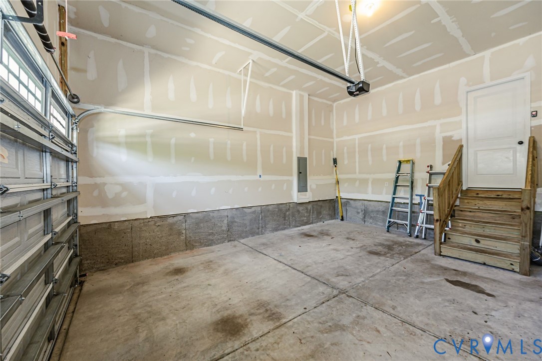 7435 Wicks Road Williamsburg, VA 23188 - Photo 81 of 82 Spacious garage featuring a concrete floor, an ove