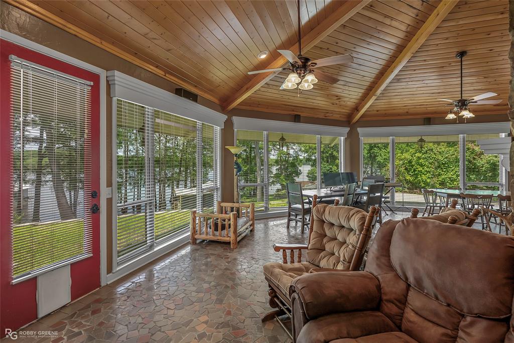 10865 Ferry Lake Road Oil City, LA 71061 - Photo 17 of 36 Sunroom featuring wood ceiling and stone finish floors