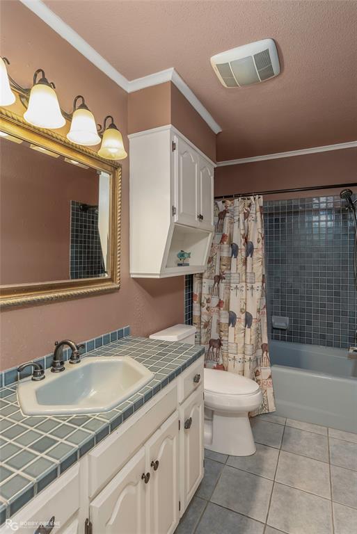 10865 Ferry Lake Road Oil City, LA 71061 - Photo 26 of 36 Bathroom with vanity, crown molding, tile patterned flooring, shower / tub combo, and a textured ceiling