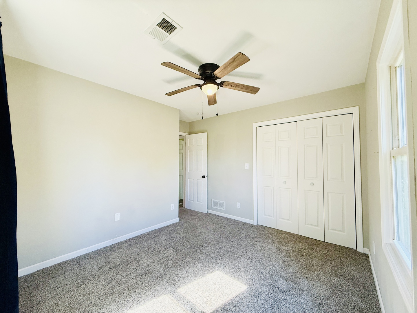 715 8th Street Colona, IL 61241 - Photo 9 of 14 a view of a room with a ceiling fan and a window