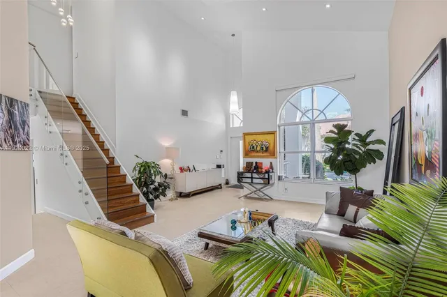 a view of a dining room with furniture large windows and wooden floor