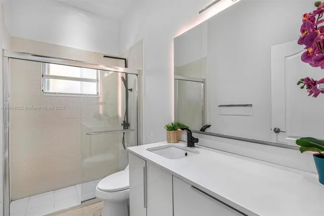 a bathroom with a sink vanity and a mirror
