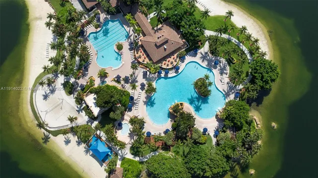 an aerial view of a house with a yard and swimming pool