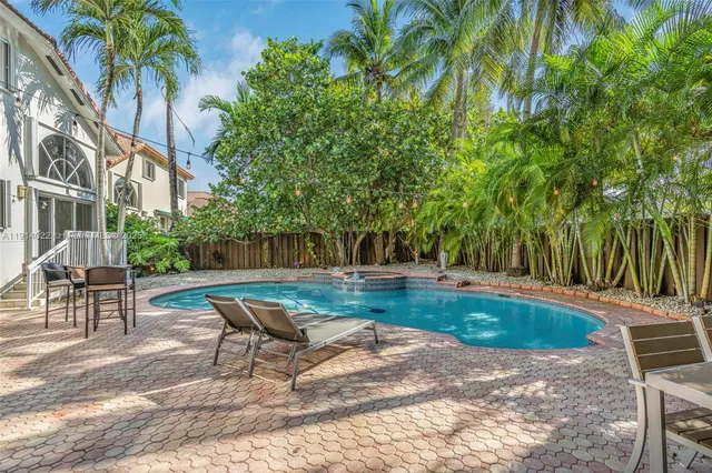 a swimming pool with outdoor seating and yard