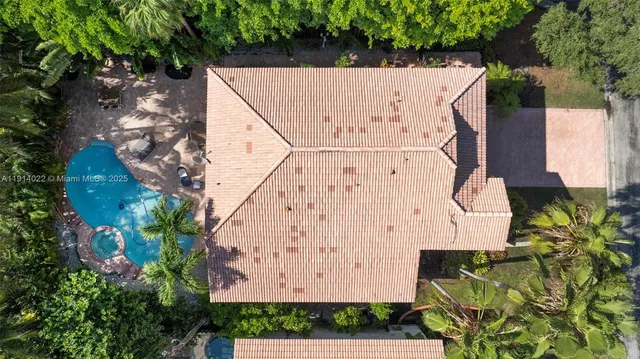 a front view of a house with a yard and potted plants
