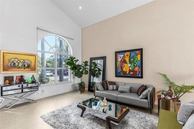 a living room with furniture and flowers