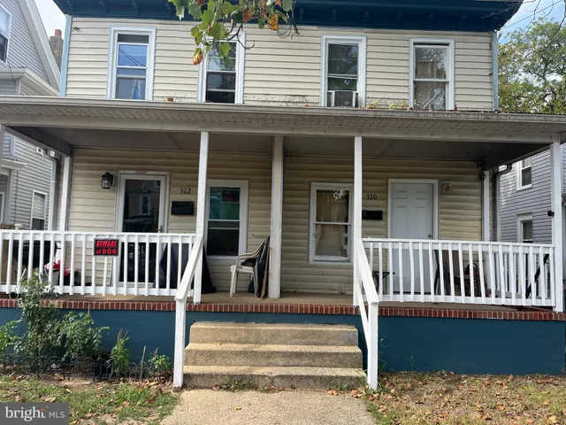 a view of a house with a wooden deck