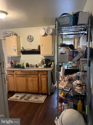 a kitchen with lots of counter top space and wooden floor