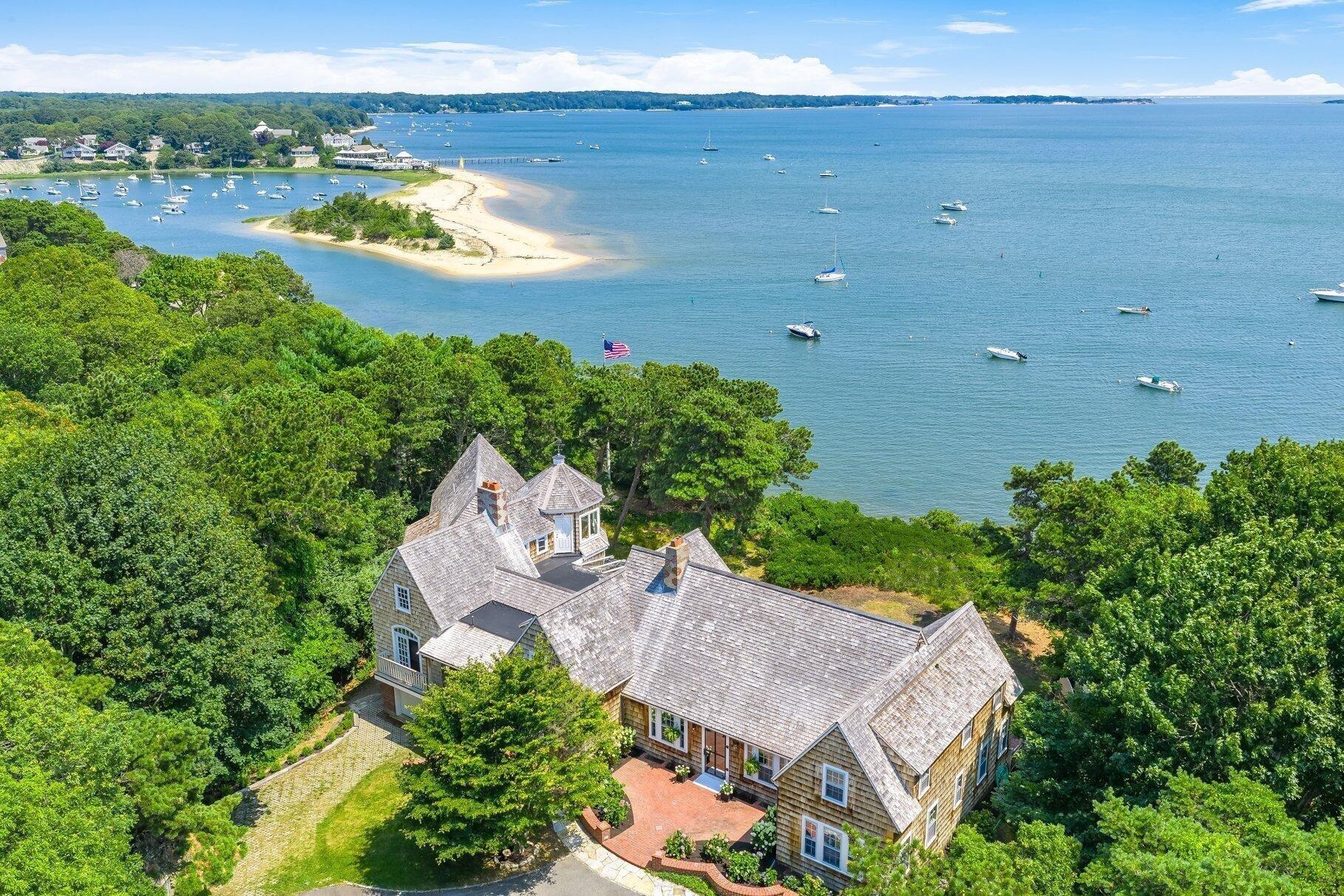an aerial view of a house with a garden and lake view