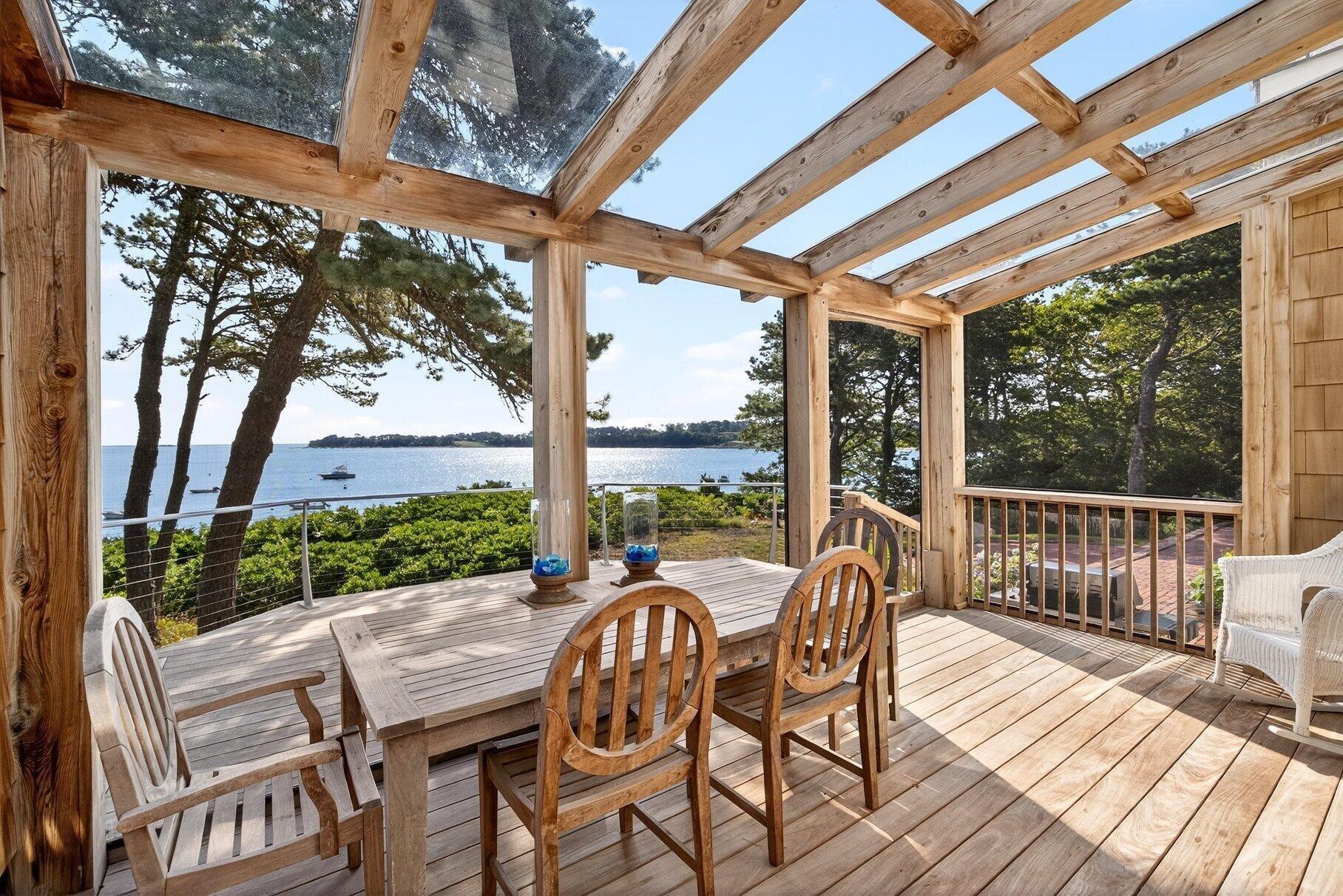 2079 Head Of The Bay Road Harwich, MA 02645 - Photo 14 of 43 a patio with wooden floor a yard a table and chairs