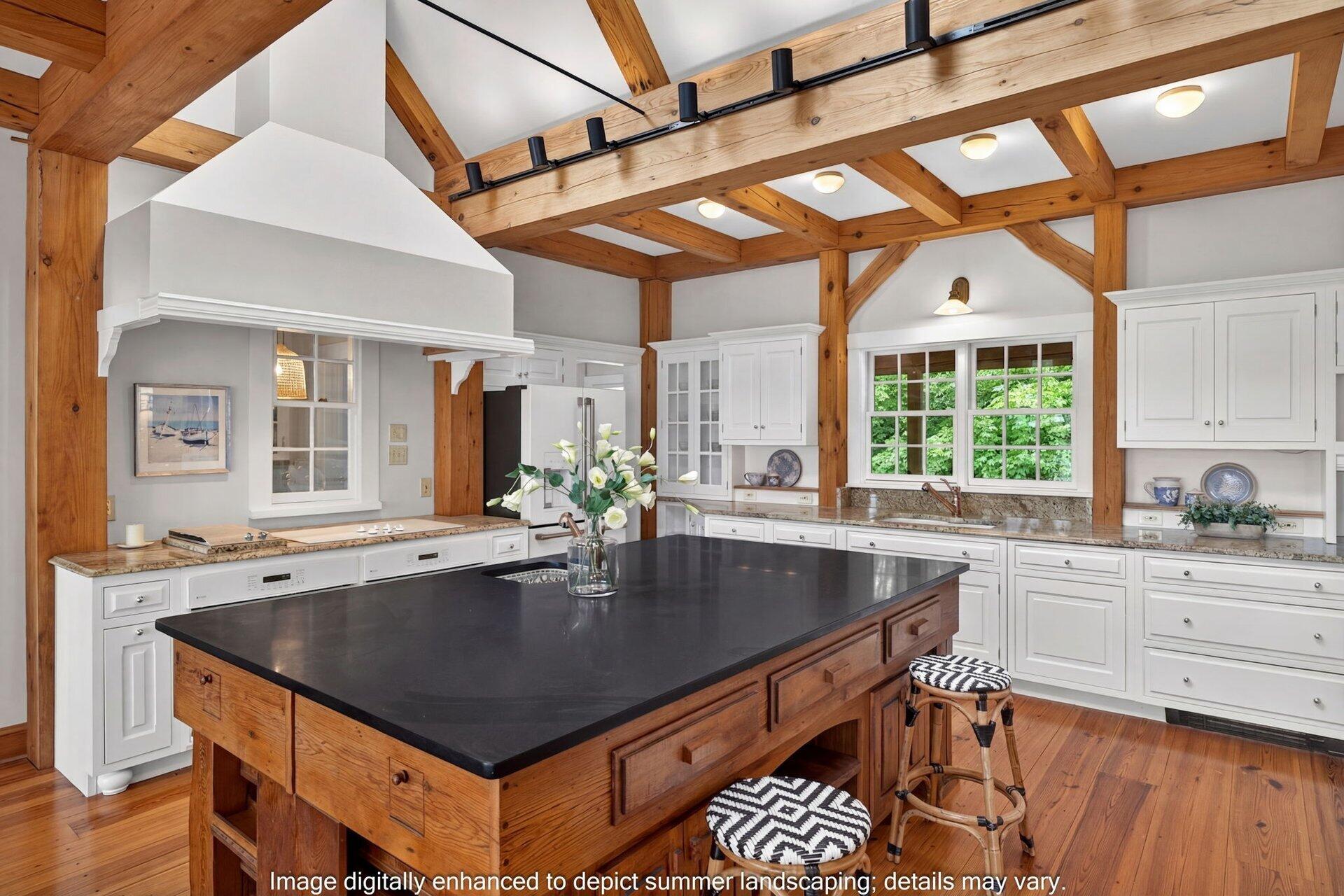 2079 Head Of The Bay Road Harwich, MA 02645 - Photo 18 of 43 a kitchen with a stove a sink dishwasher a dining table and chairs with wooden floor