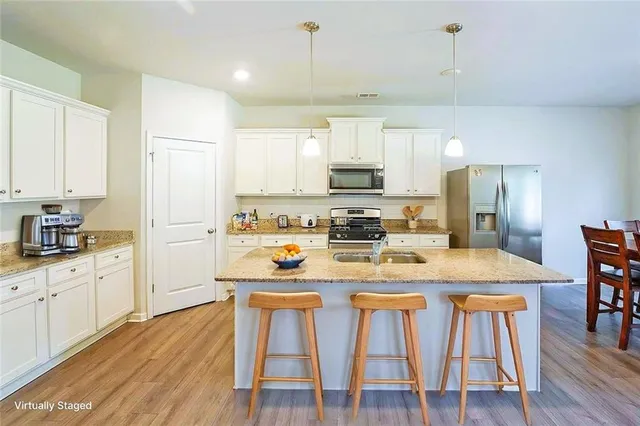 a spacious bathroom with a granite countertop sink mirror and a
