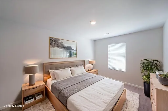 a bed room with a bed and a potted plant