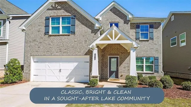 a kitchen with stainless steel appliances granite countertop a stove a refrigerator a kitchen island a sink and white cabinets with wooden floor