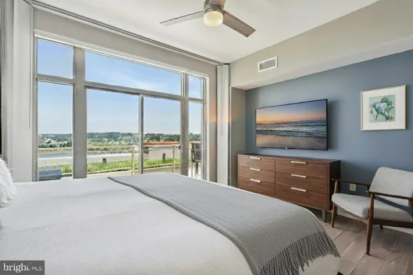 a bedroom with a bed and a painting on the wall