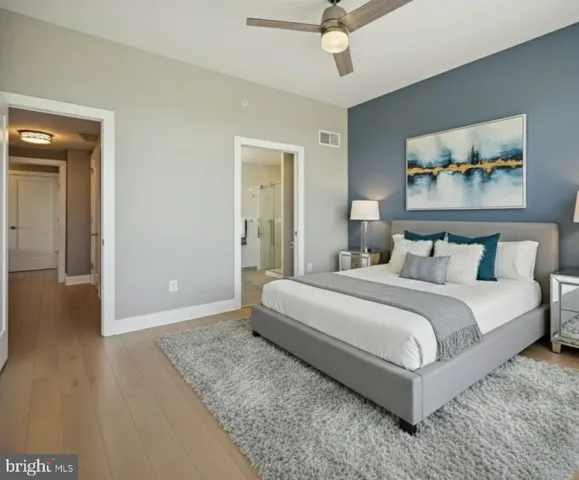 a bedroom with a bed and a painting on the wall