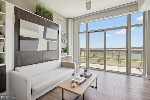 a living room with furniture and a large window with outer view