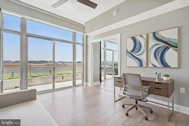 a view of a workspace with furniture and a window