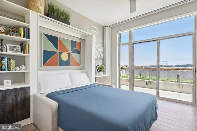 a bedroom with a large bed and a book shelf