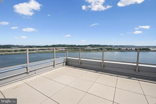 a view of a big room with wooden floor and a kitchen