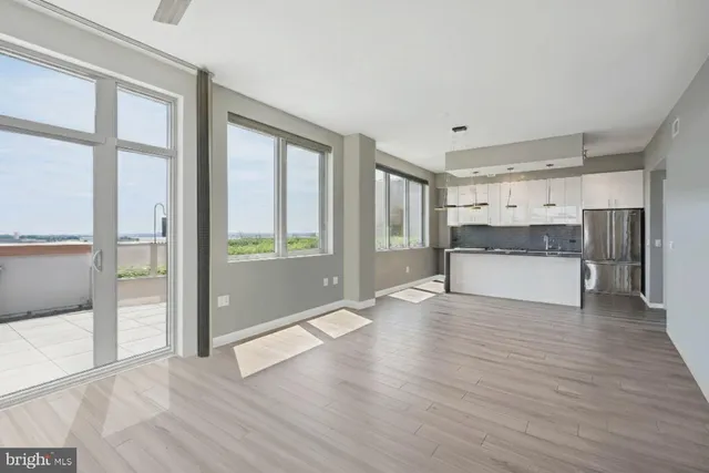 a view of a room with wooden floor and bathroom