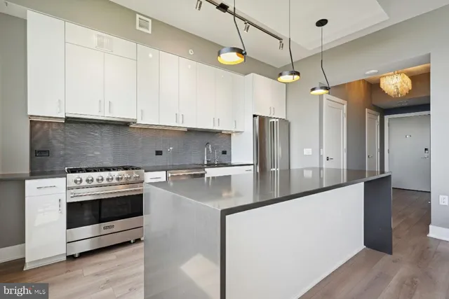 a living room with a couch and a wooden floor