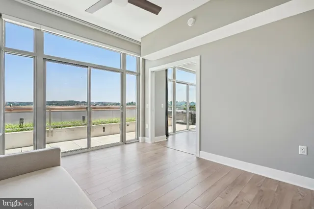 a living room with furniture a large window with kitchen view