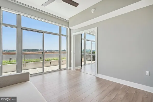 a view of a patio with dining table and chairs under an umbrella
