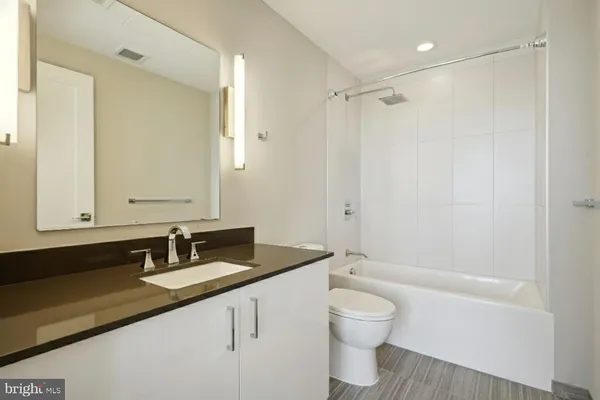 a living room with furniture a rug and a floor to ceiling window