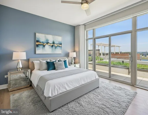 a bedroom with a large bed and a flat screen tv