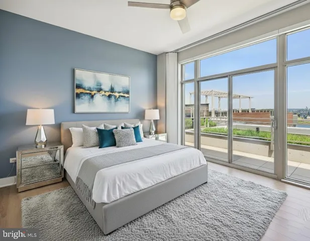 a bedroom with a large bed and a large window