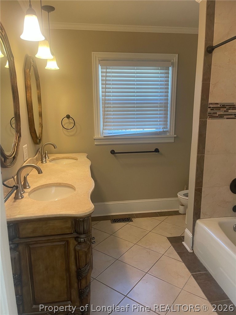 2515 Fort Bragg Road Fayetteville, NC 28303 - Photo 16 of 23 a bathroom with a sink a toilet and bathtub
