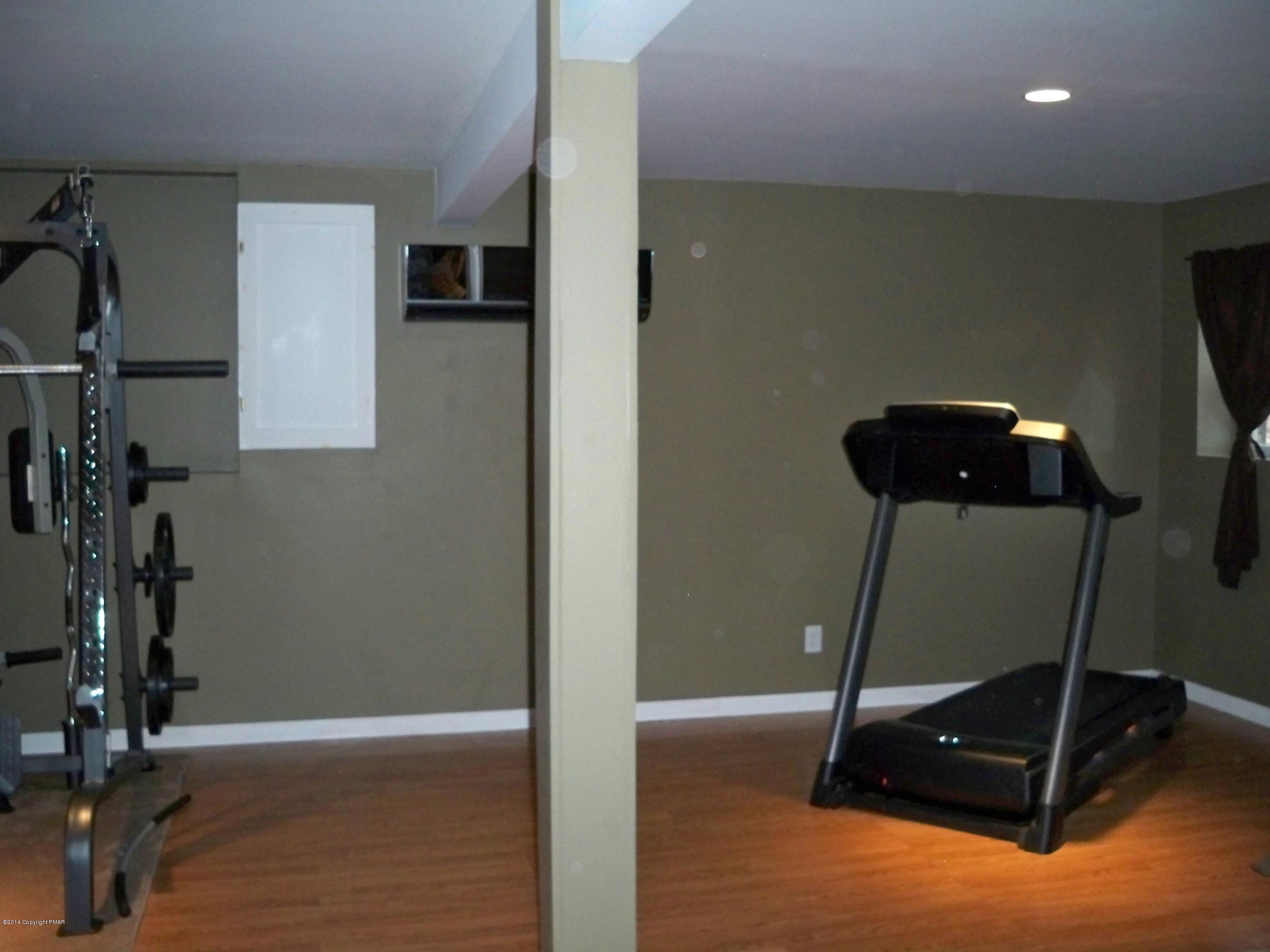 192 Timber Hill Road Henryville, PA 18332 - Photo 20 of 24 a room with gym equipment and a mirror