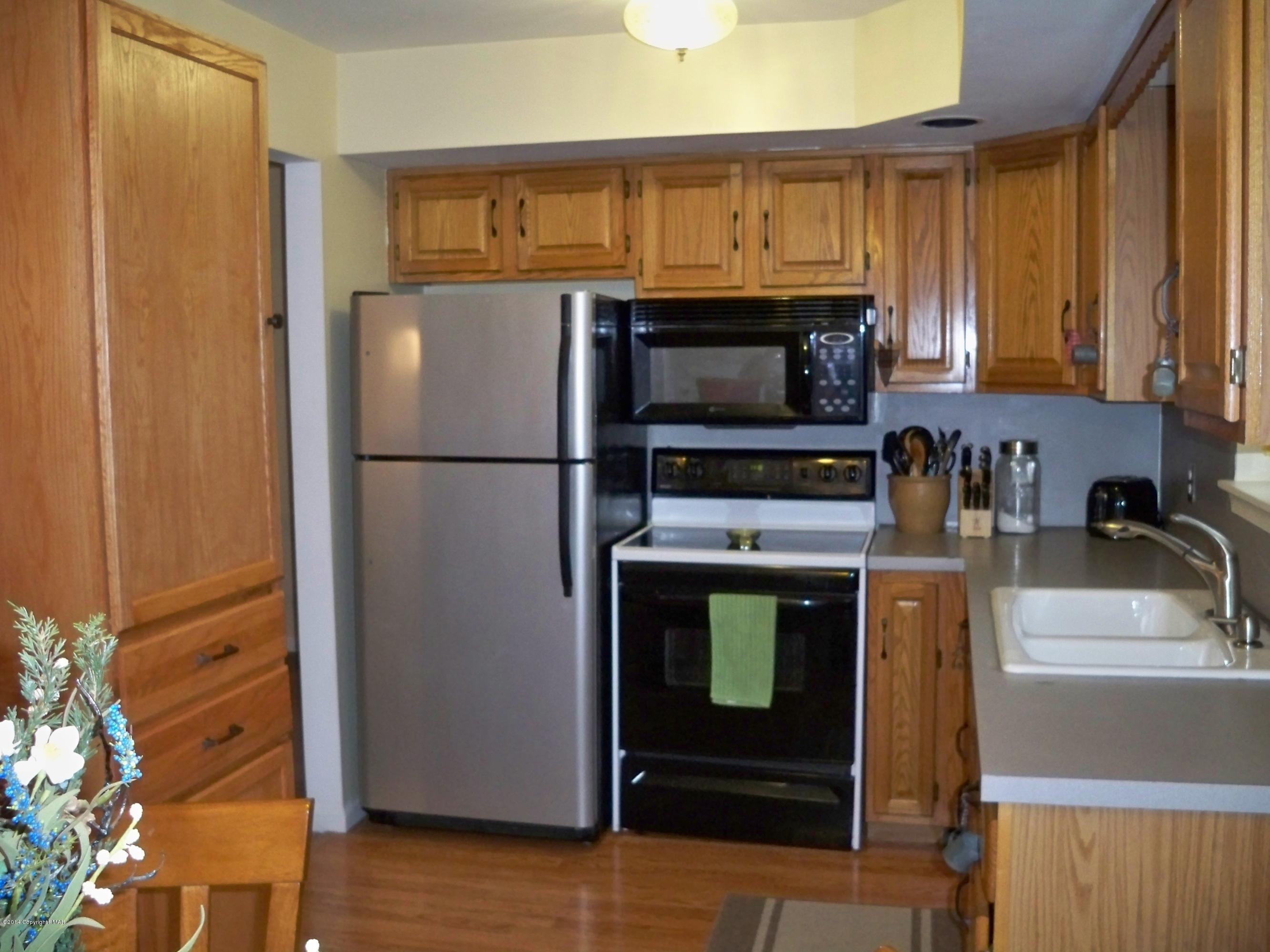 192 Timber Hill Road Henryville, PA 18332 - Photo 4 of 24 a kitchen with a refrigerator sink and microwave