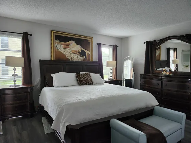 a bedroom with a bed and a dresser