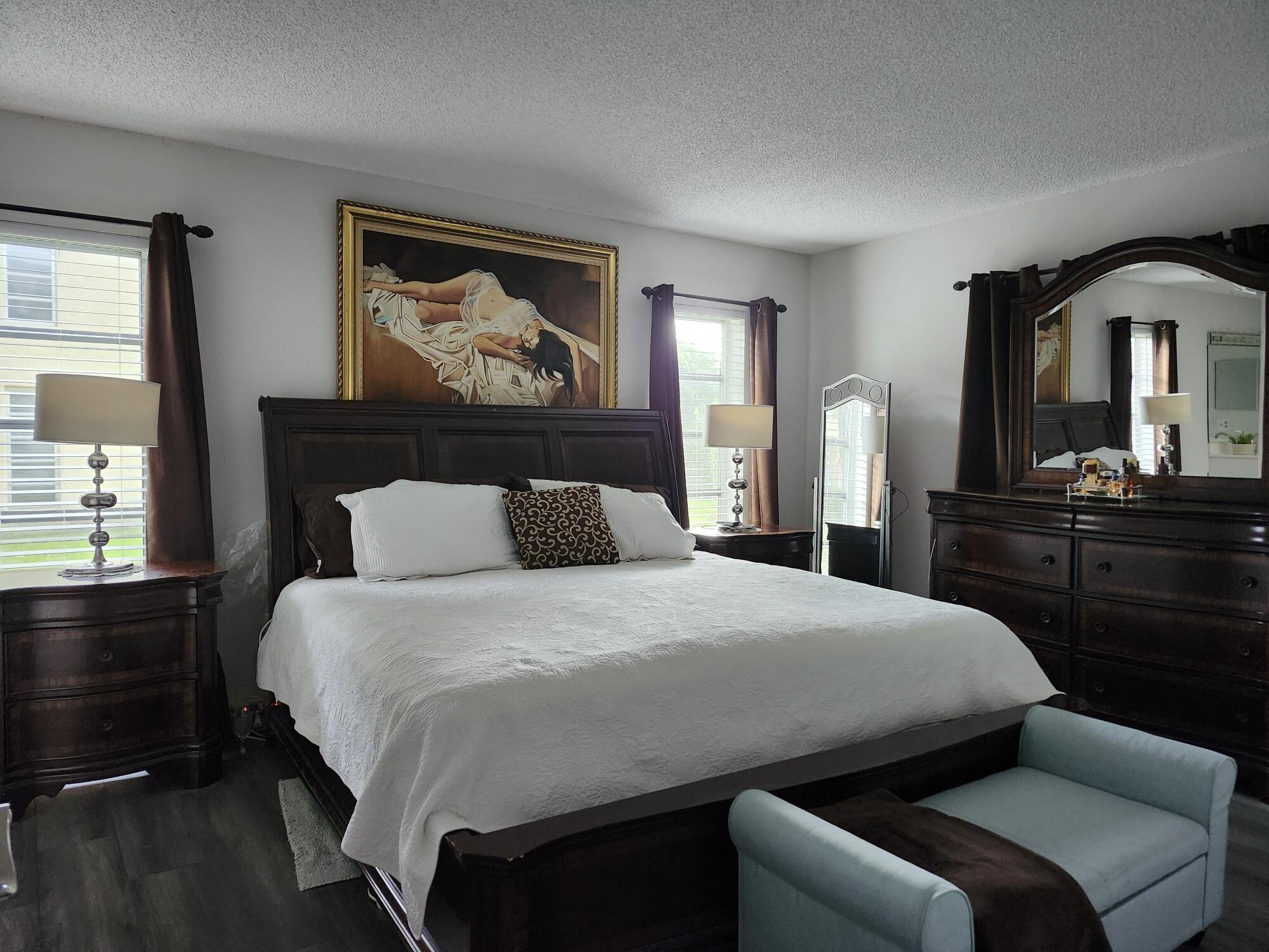 1141 Calamondin Terrace, Unit 101 Delray Beach, FL 33445 - Photo 14 of 21 a bedroom with a bed and a dresser