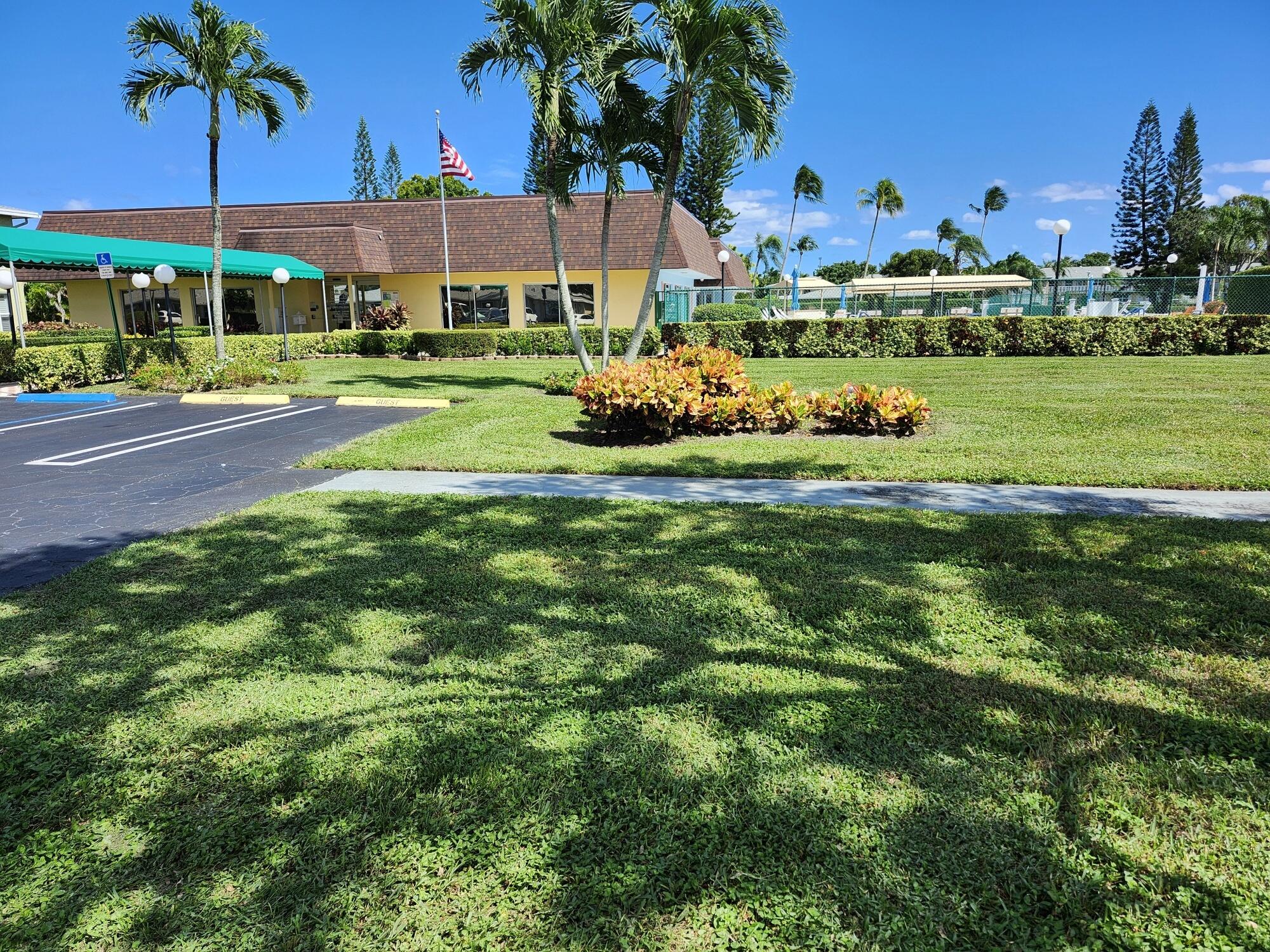 1141 Calamondin Terrace, Unit 101 Delray Beach, FL 33445 - Photo 20 of 21 a front view of a building with garden