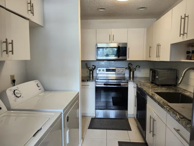 a kitchen with a sink a stove and cabinets