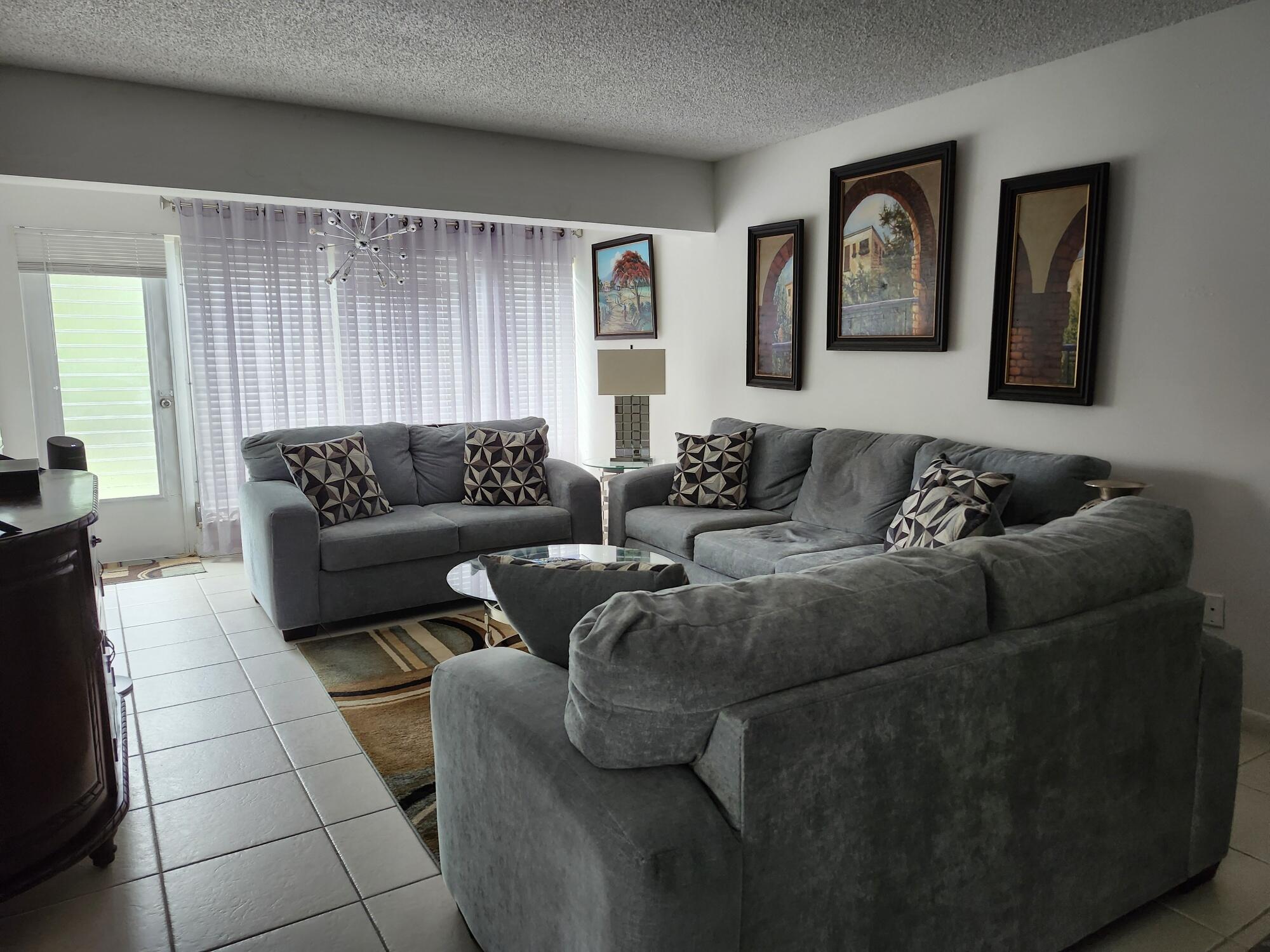 1141 Calamondin Terrace, Unit 101 Delray Beach, FL 33445 - Photo 10 of 21 a living room with furniture and a couch