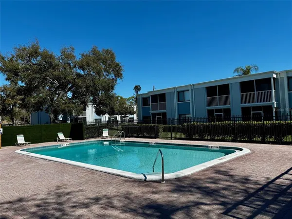 a view of a house with swimming pool and yard