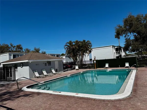 a view of a swimming pool with chairs