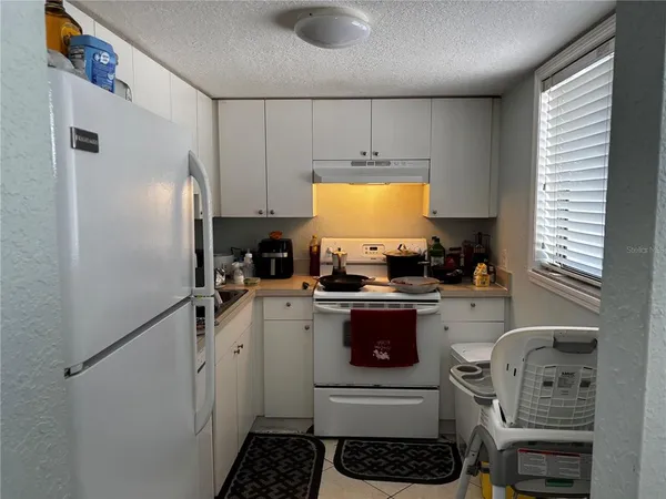 a kitchen with a sink appliances and cabinets