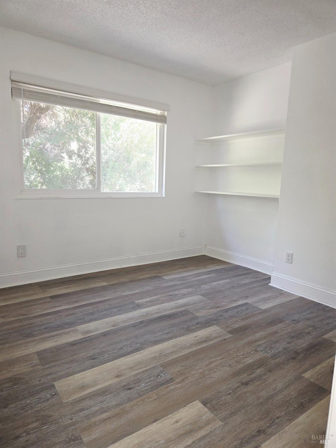 140 Del Rio Court, Unit 4 Vacaville, CA 95687 - Photo 12 of 25 a view of empty room with wooden floor and fan