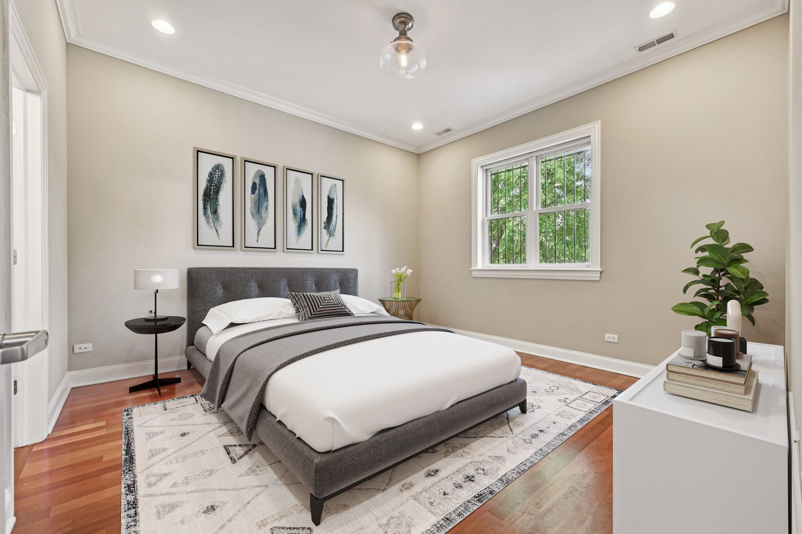 2248 North Racine Avenue, Unit 3 Chicago, IL 60614 - Photo 11 of 32 a bedroom with a large bed and a chandelier