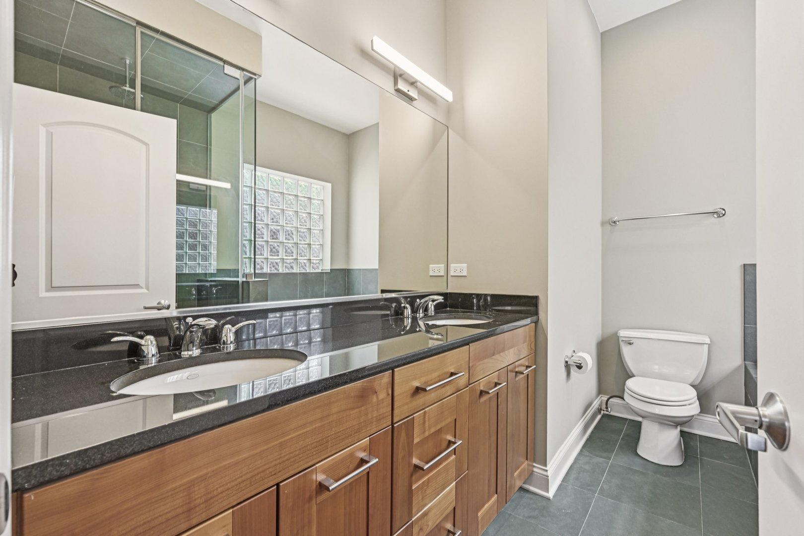 2248 North Racine Avenue, Unit 3 Chicago, IL 60614 - Photo 14 of 32 a bathroom with a granite countertop sink mirror vanity and toilet