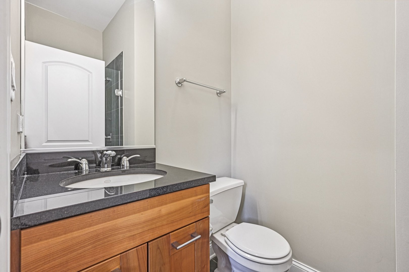 2248 North Racine Avenue, Unit 3 Chicago, IL 60614 - Photo 19 of 32 a bathroom with a granite countertop toilet sink mirror and vanity