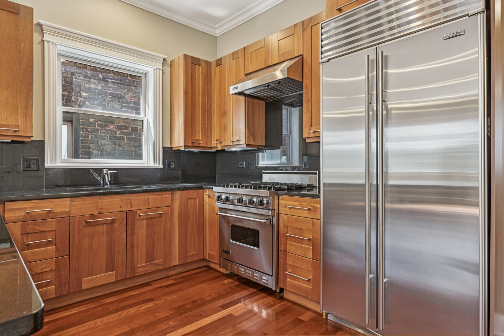 2248 North Racine Avenue, Unit 3 Chicago, IL 60614 - Photo 7 of 32 a kitchen with stainless steel appliances granite countertop a refrigerator and a sink