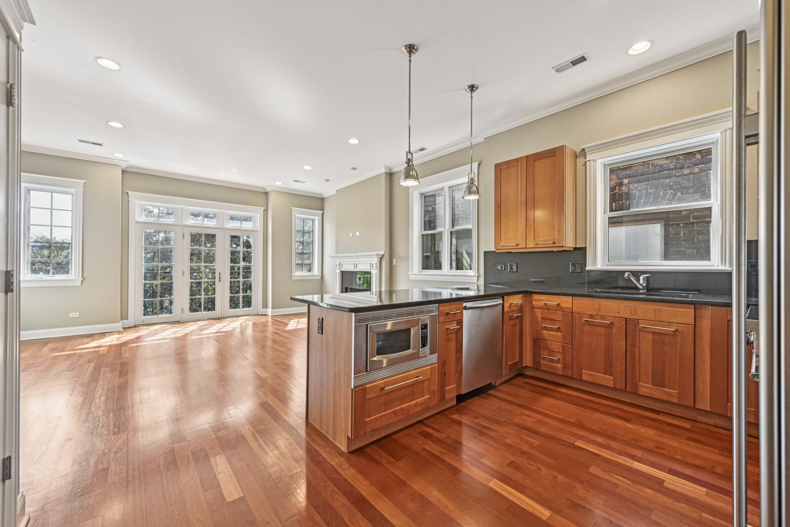 2248 North Racine Avenue, Unit 3 Chicago, IL 60614 - Photo 9 of 32 a large kitchen with stainless steel appliances granite countertop a stove a sink and a granite counter tops with wooden floors
