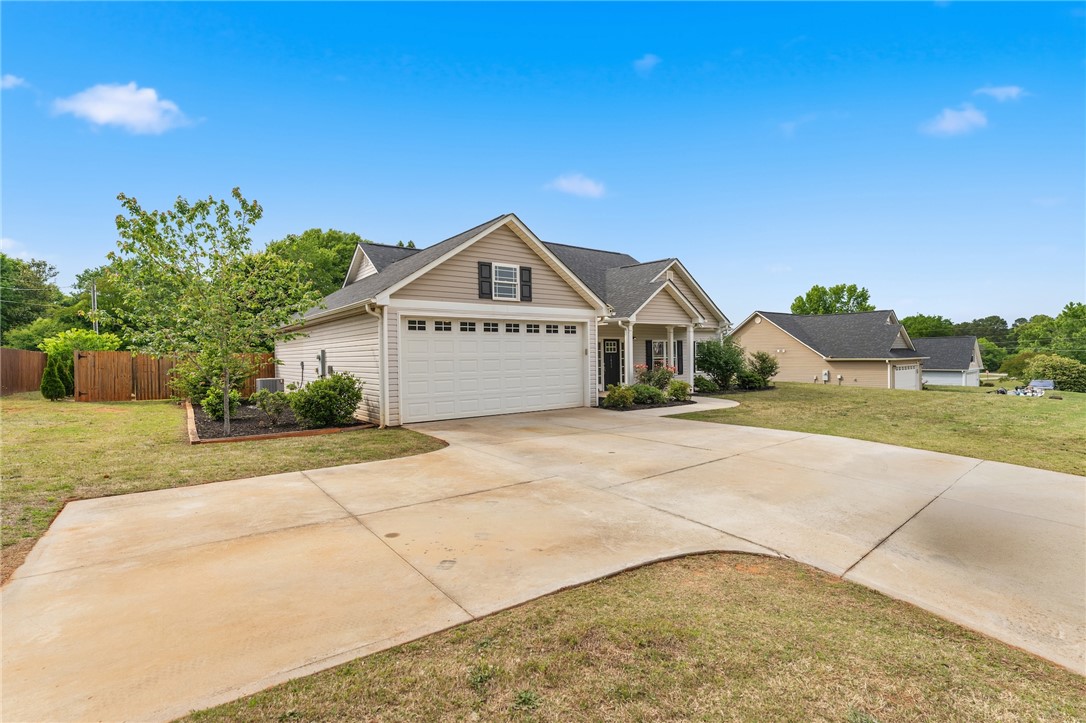 1411 Dunn Road Anderson, SC 29625 - Photo 30 of 30 This inviting home features a paved driveway, attached garage, and well-maintained landscaping.
