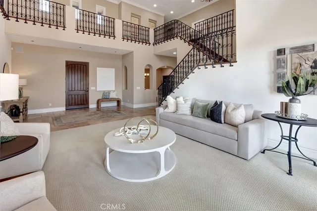 a dining room with furniture a chandelier and window
